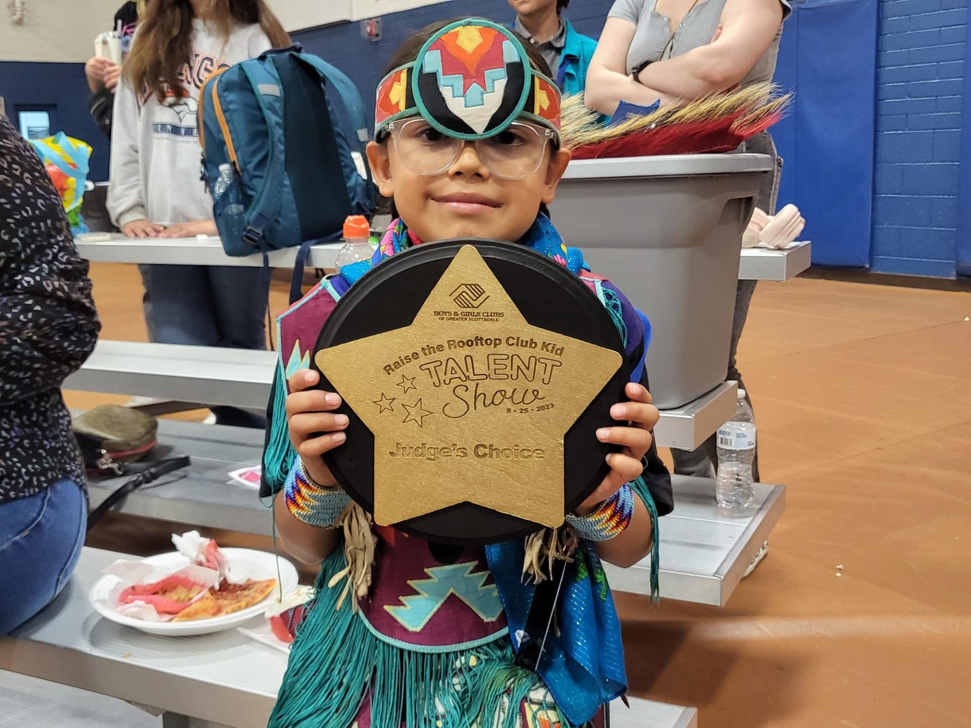 Young Community Member Performs Traditional Fancy Dance at Boys & Girls Club Event